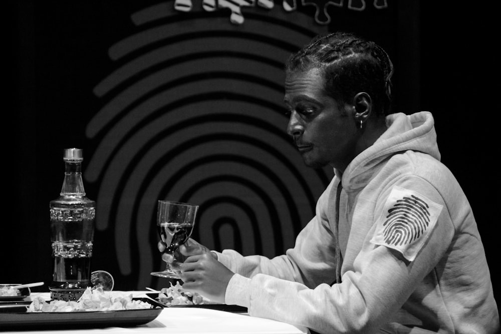 man in white dress shirt sitting beside table