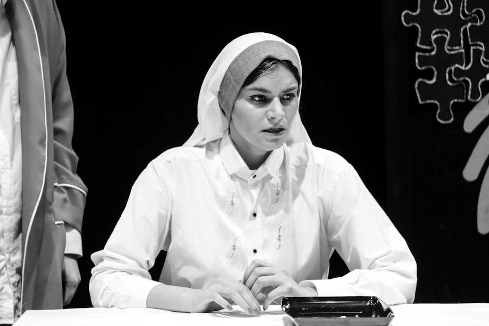 woman in white hijab and white dress shirt