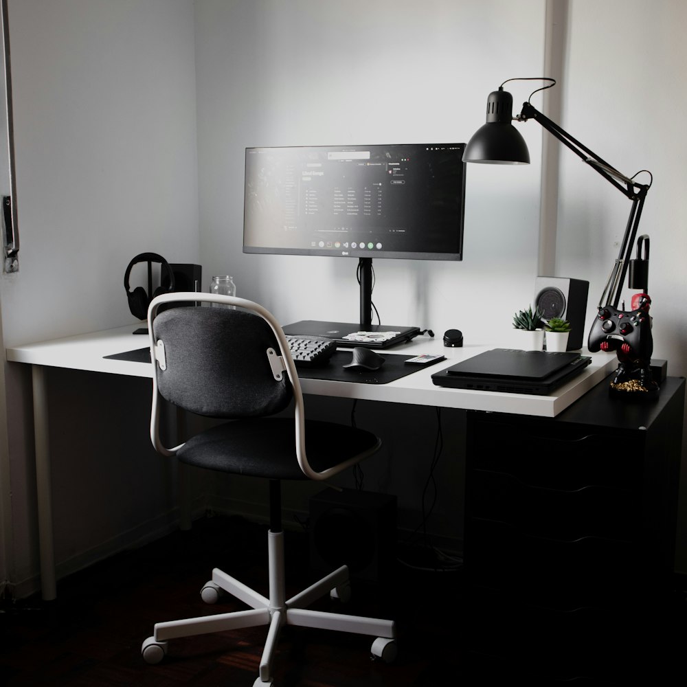 black flat screen computer monitor on brown wooden desk