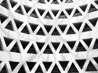 Architectural detail of a building facade with geometric patterns and shadows.