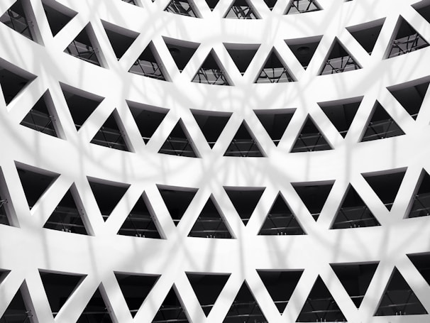 Architectural detail of a building facade with geometric patterns and shadows.