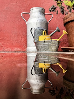 gray metal tank on red brick wall