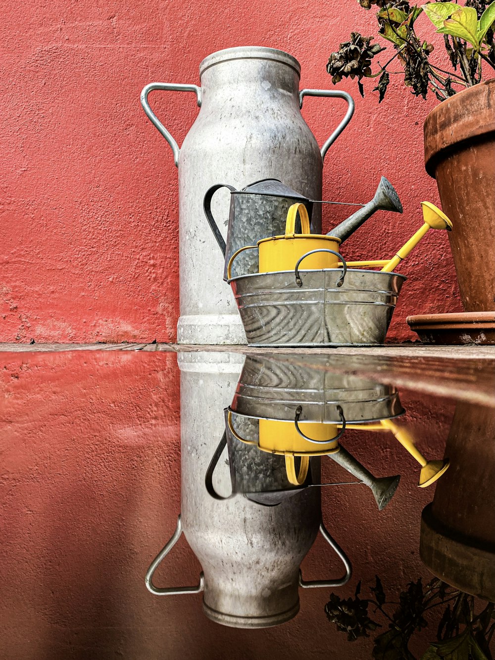 gray metal tank on red brick wall