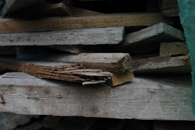 Stack of aged wood planks ready for a porch repair project.