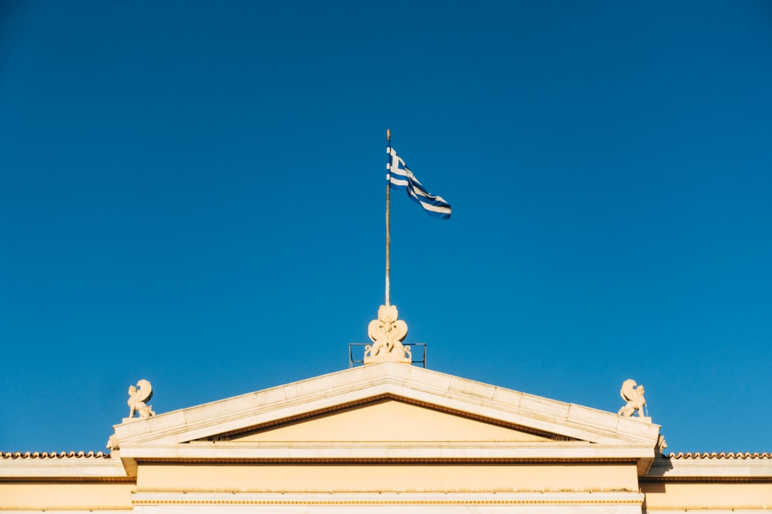 white and brown wooden building with us flag on top under blue sky during daytime