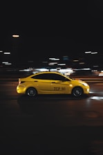 yellow porsche 911 on road during night time