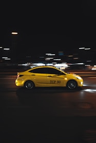 yellow porsche 911 on road during night time