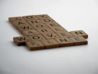 A cheerful moment from a casual word puzzle game with bright letters and friendly design.