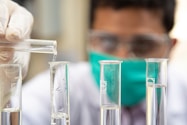 clear glass test tubes on blue plastic container