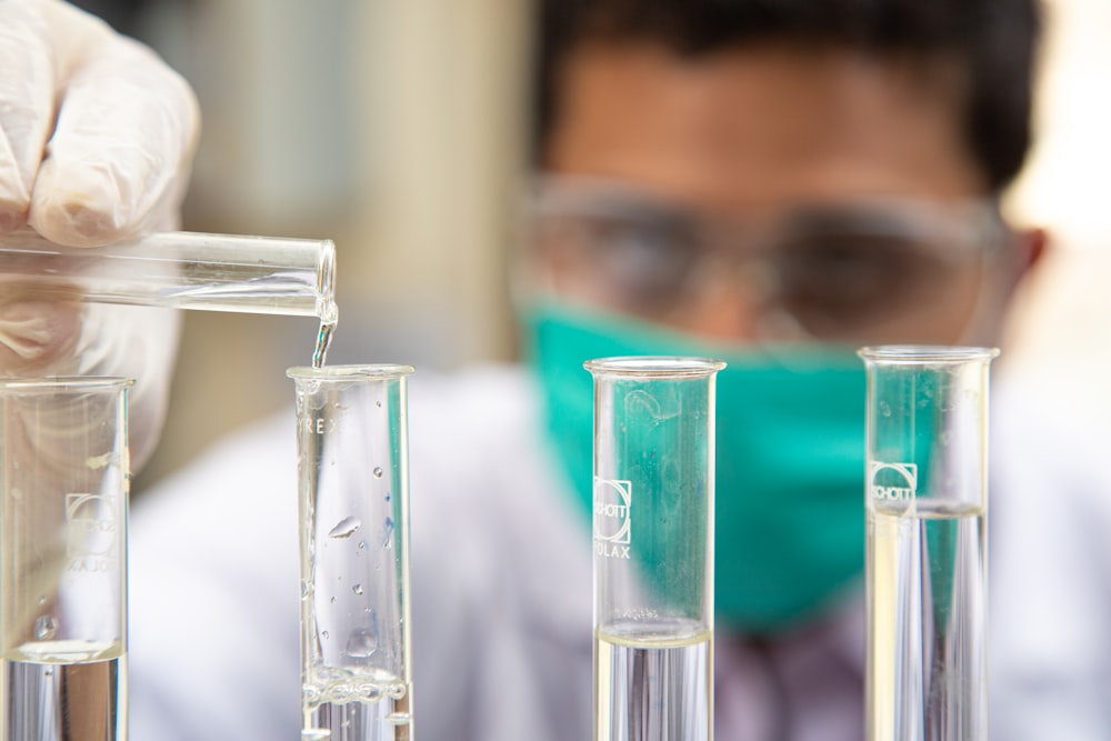 clear glass test tubes on blue plastic container