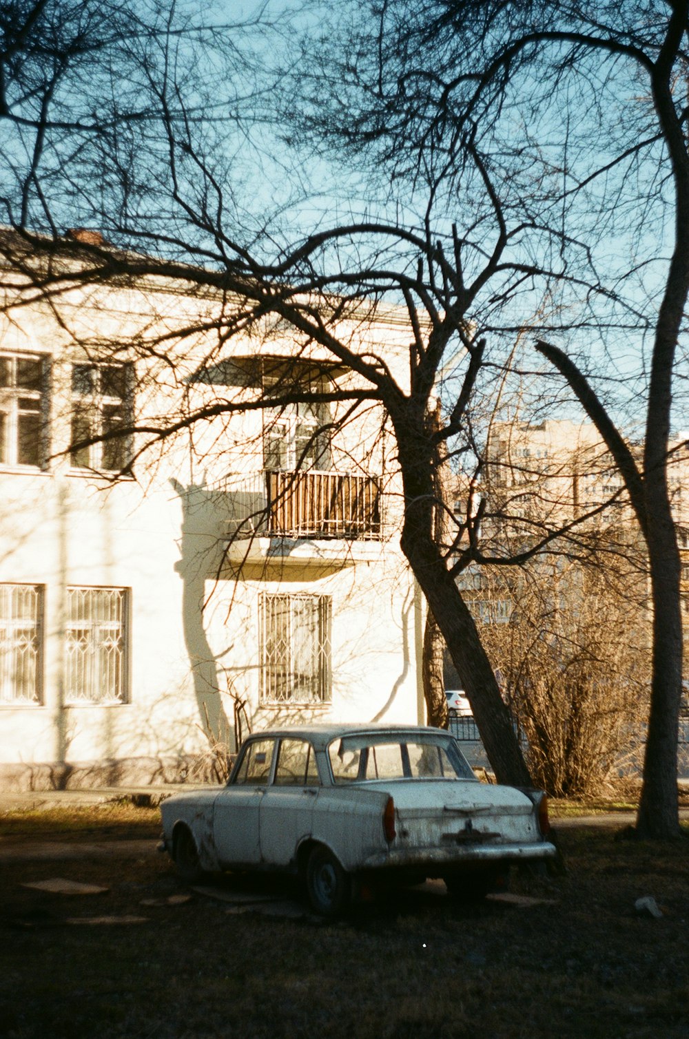 white car parked near white concrete building