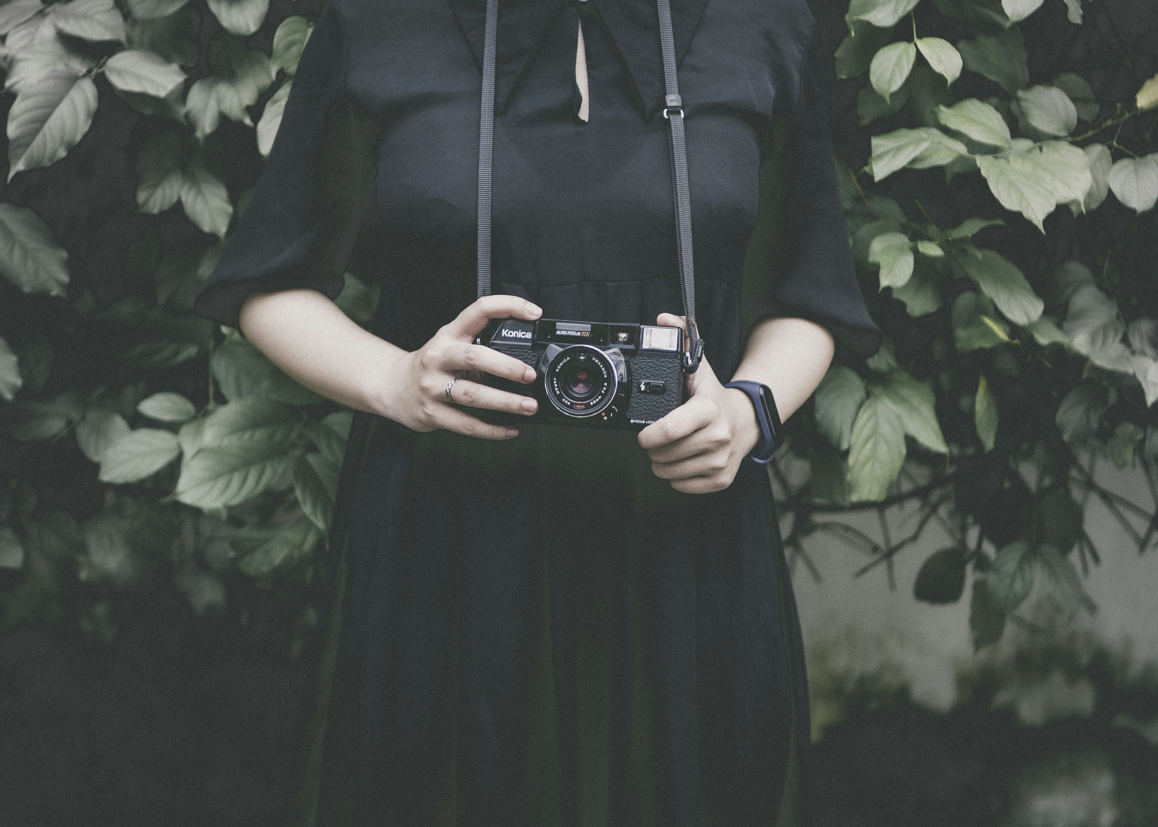 man-in-black-shirt-holding-black-and-silver-camera