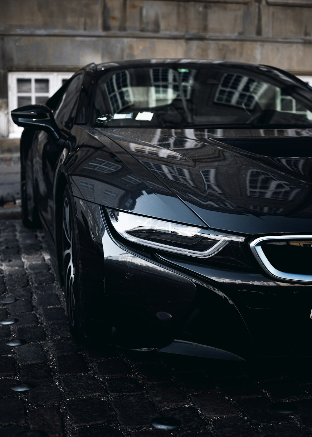 black car parked on gray brick floor