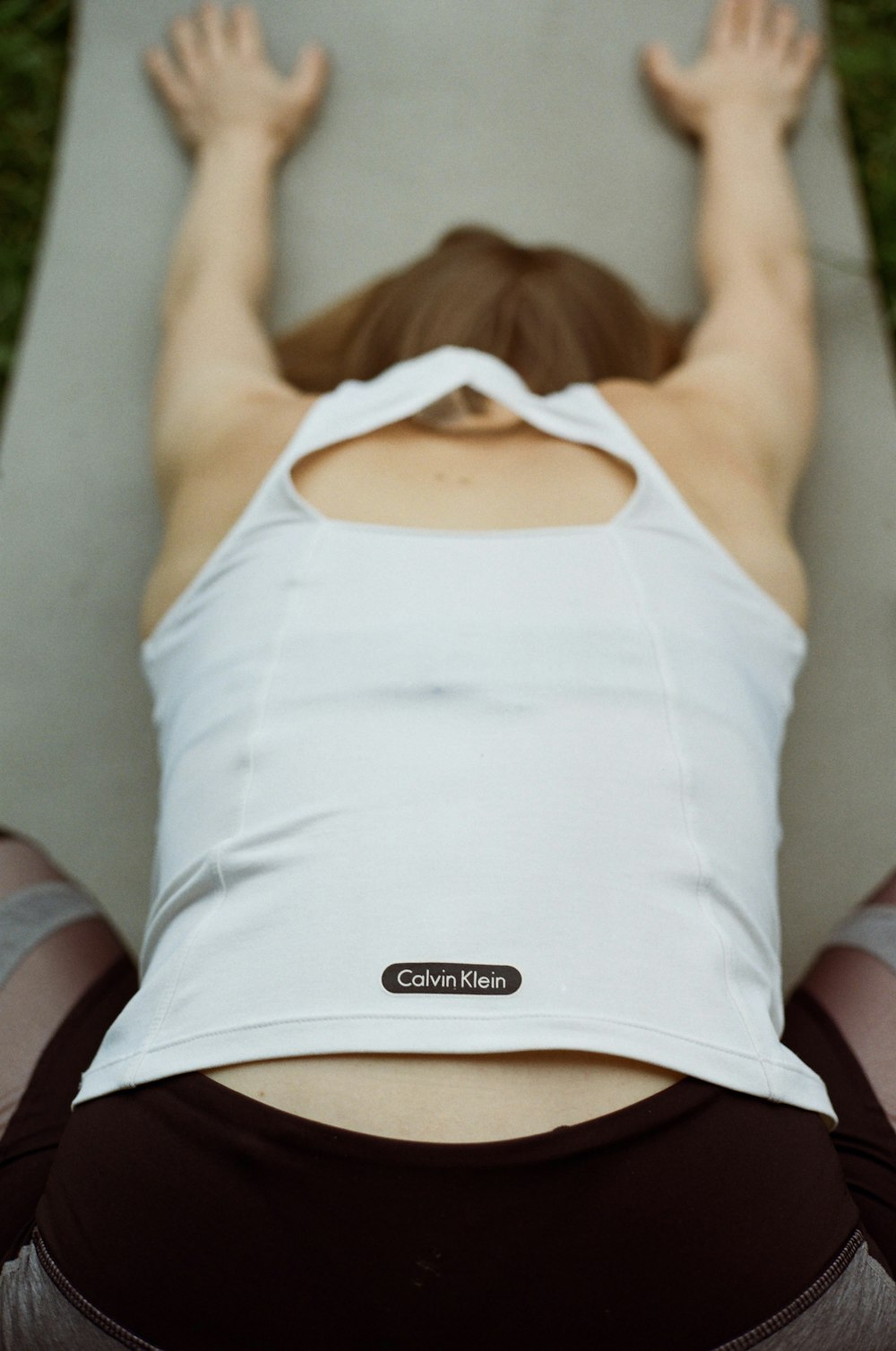 woman in white tank top lying on bed