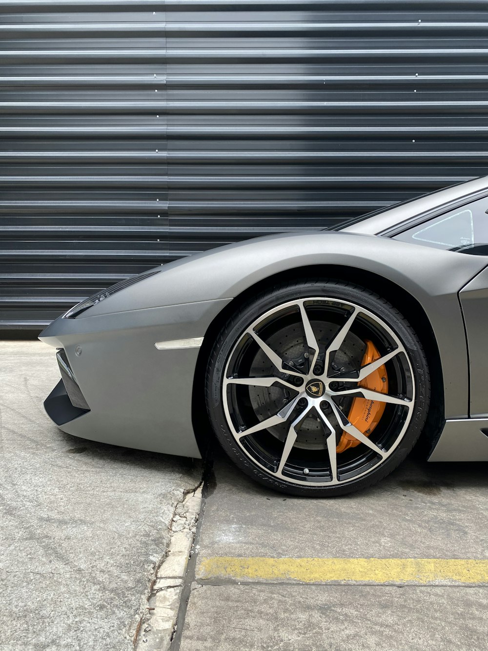 grey porsche 911 parked in garage