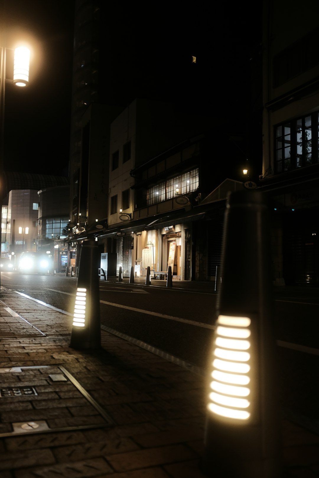 people walking on sidewalk during night time