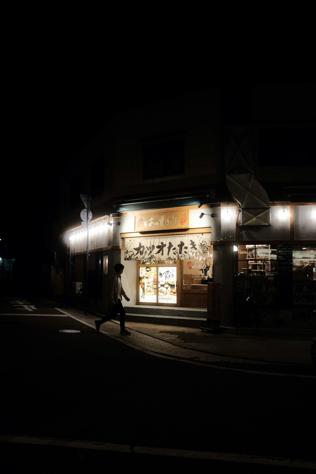 people walking on sidewalk during night time
