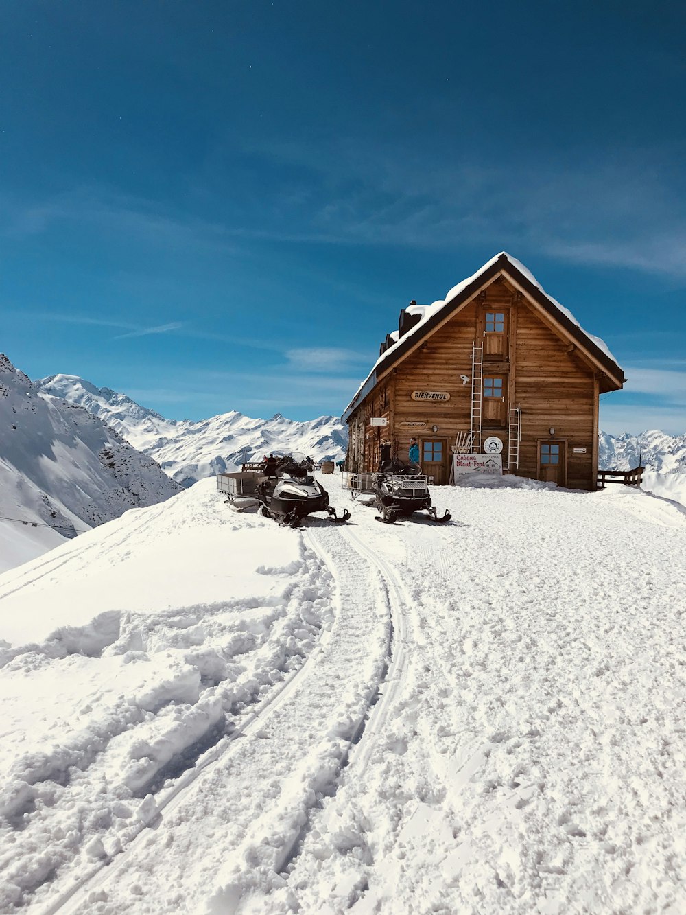 brown wooden house on snow covered ground during daytime