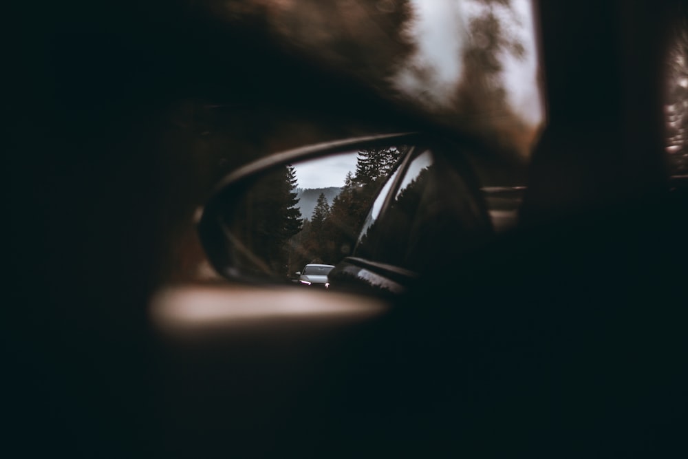 black car side mirror with white clouds