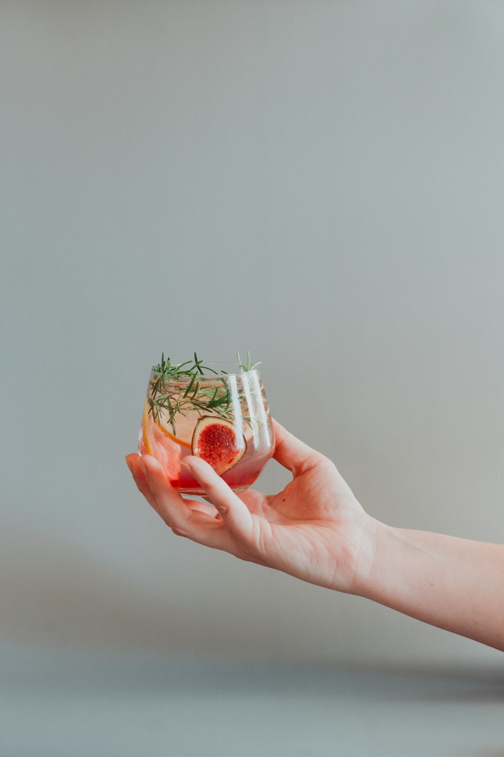 person holding white and red plastic container