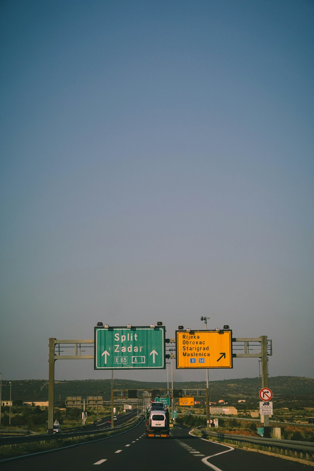 green and white road sign