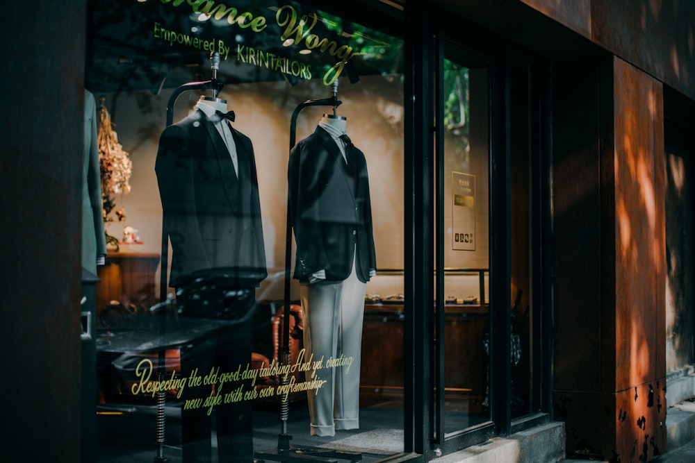 man in black jacket standing beside store