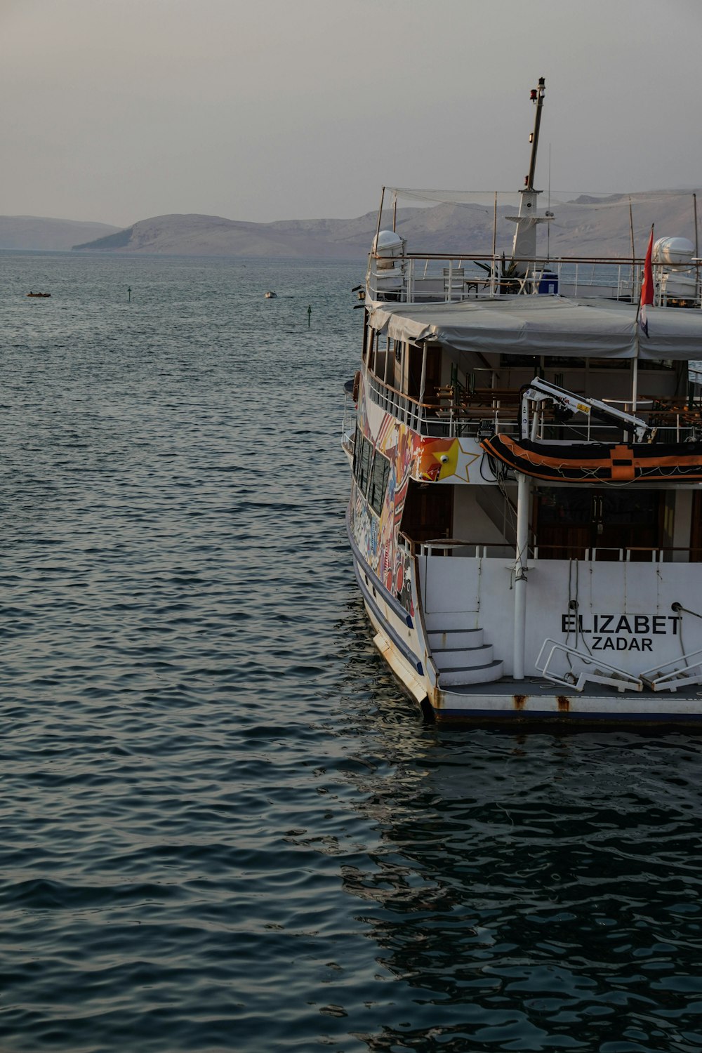 white and brown boat on sea during daytime