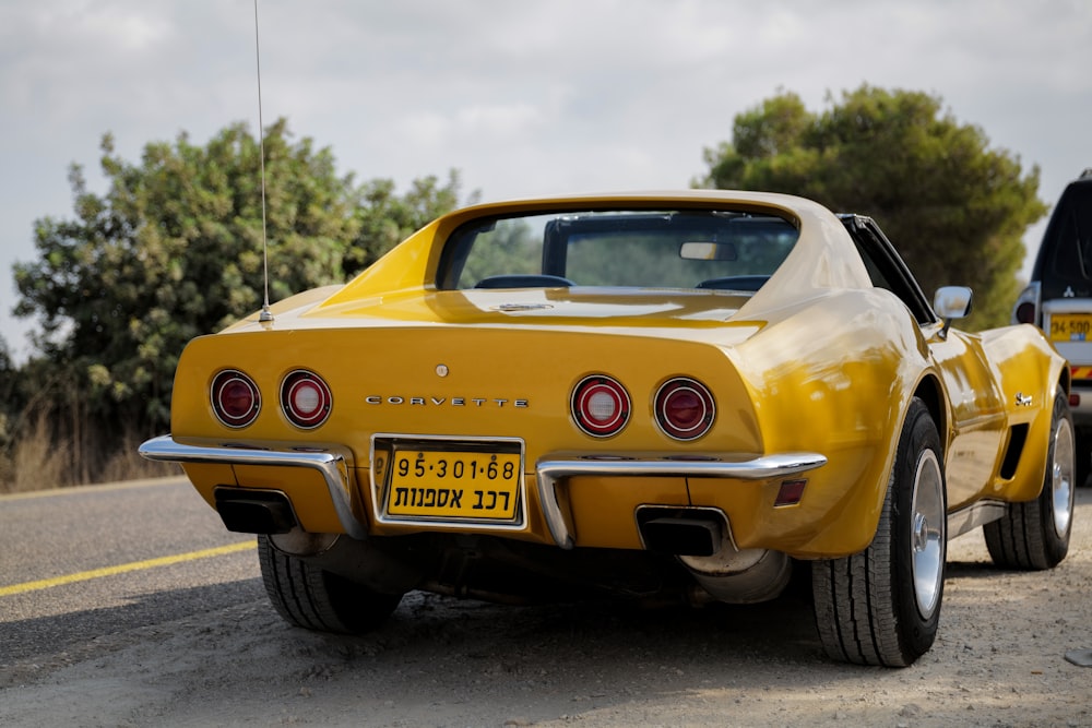 yellow chevrolet camaro on road during daytime