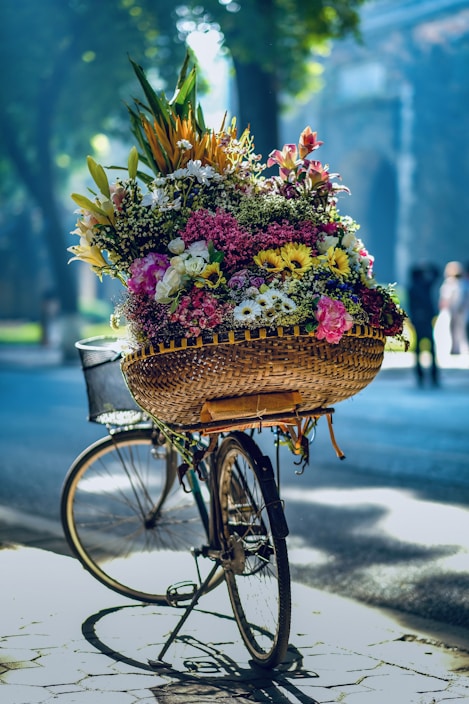 flowers in brown woven basket on bicycle