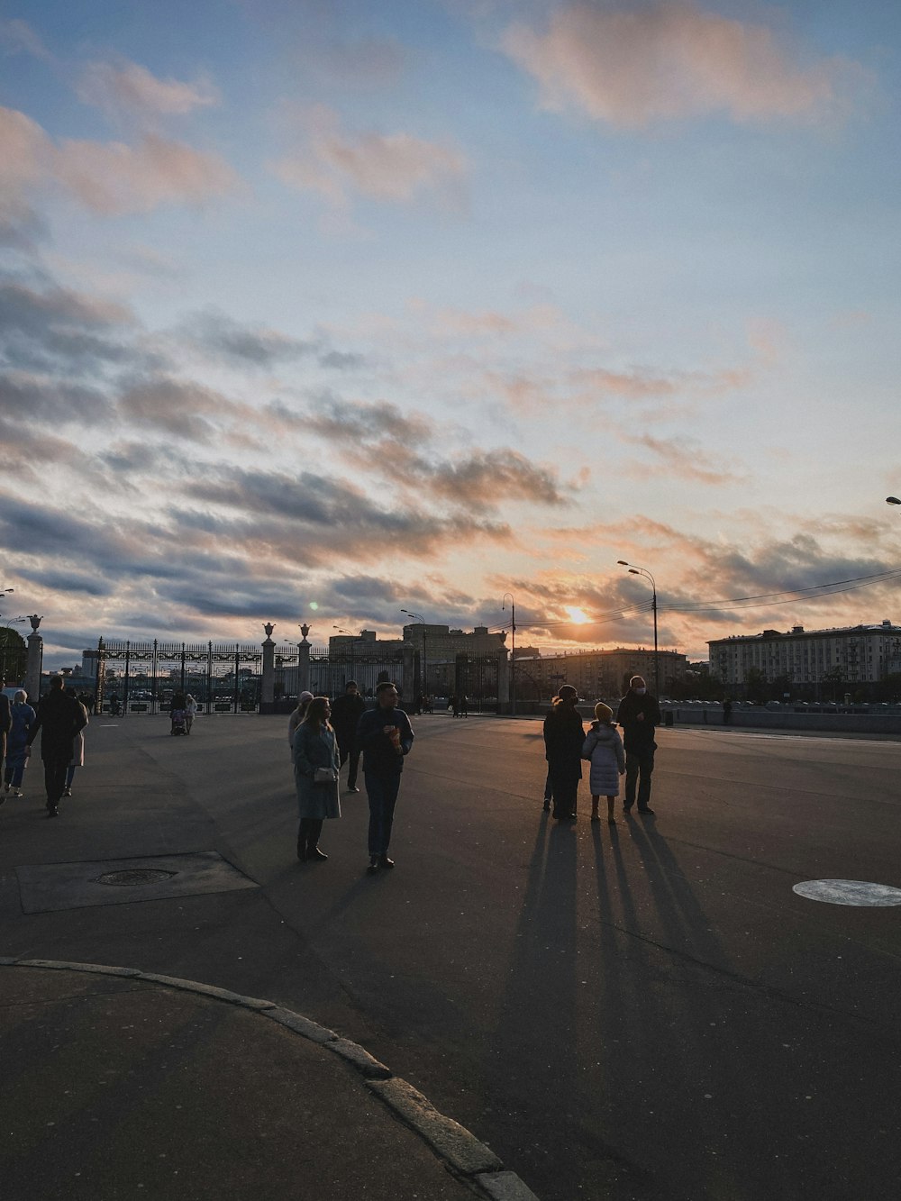 people walking on sidewalk during sunset