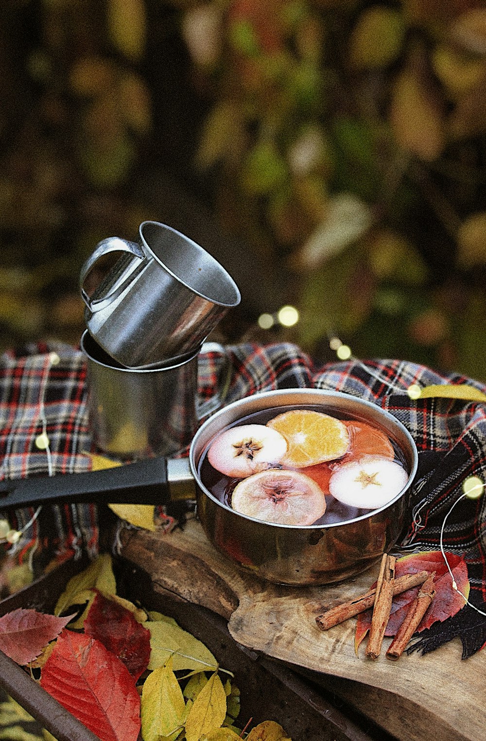 person pouring sauce on soup in stainless steel cup