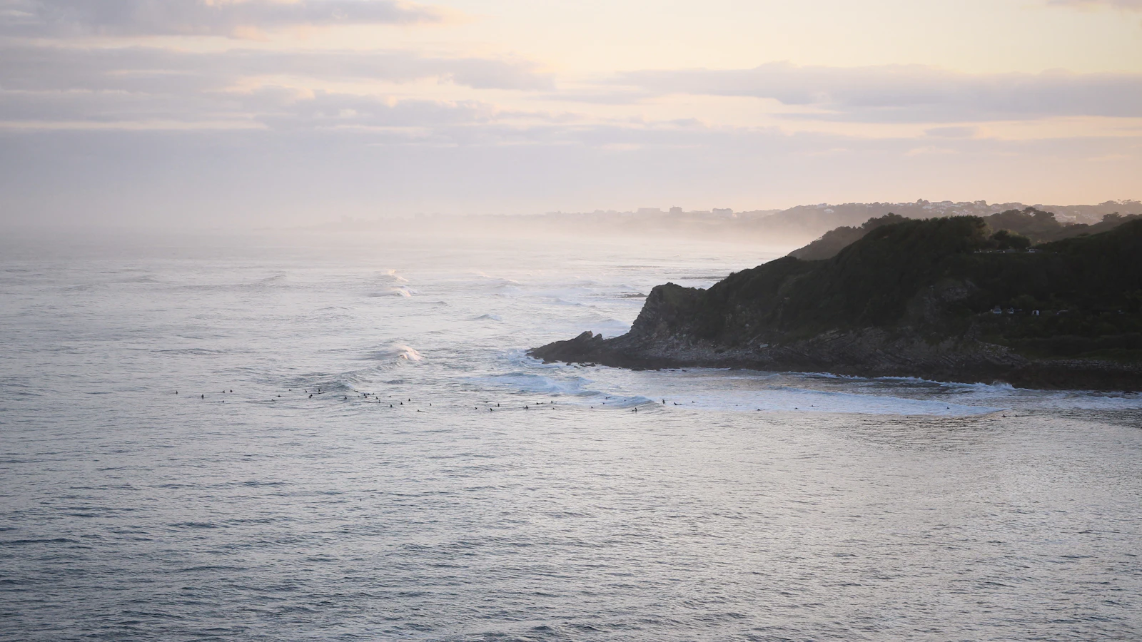 Surfers in the lineup at a Basque Coast point break near Saint-Jean-de-Luz at dawn