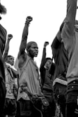 A diverse group of individuals raising their fists in solidarity.