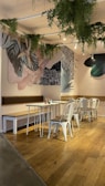 Cozy interior of Green Bite Cafe featuring natural wood furniture and green plants