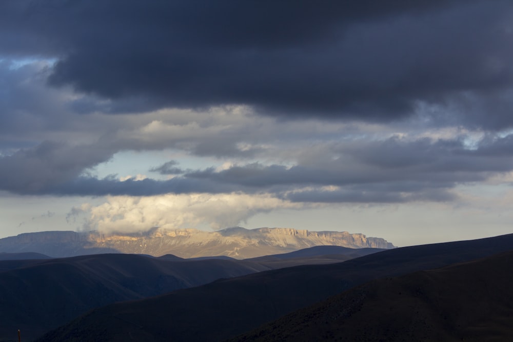 green mountains under white clouds during daytime