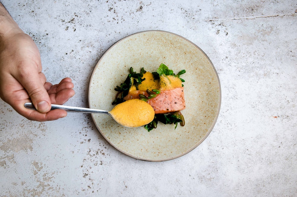 person holding stainless steel fork