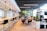 A modern coworking space with people collaborating around a large table.