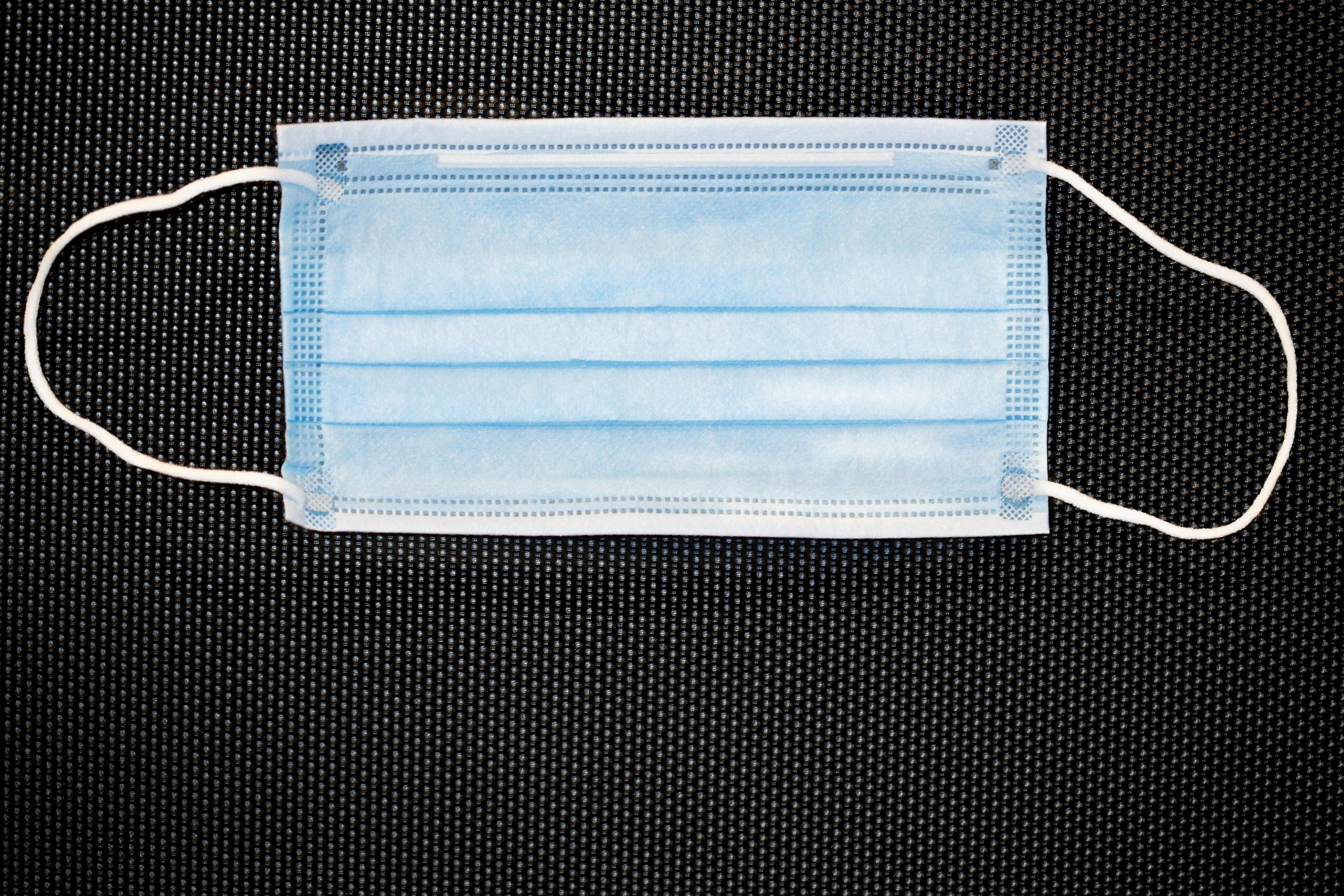 blue zip pouch on black and white checkered textile