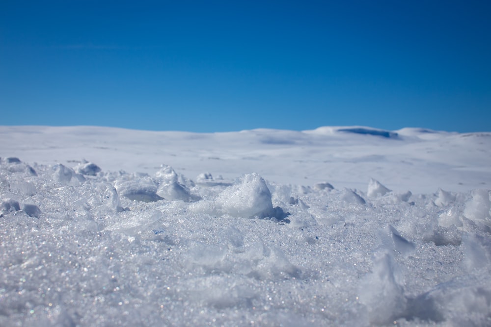 white snow on blue sky during daytime