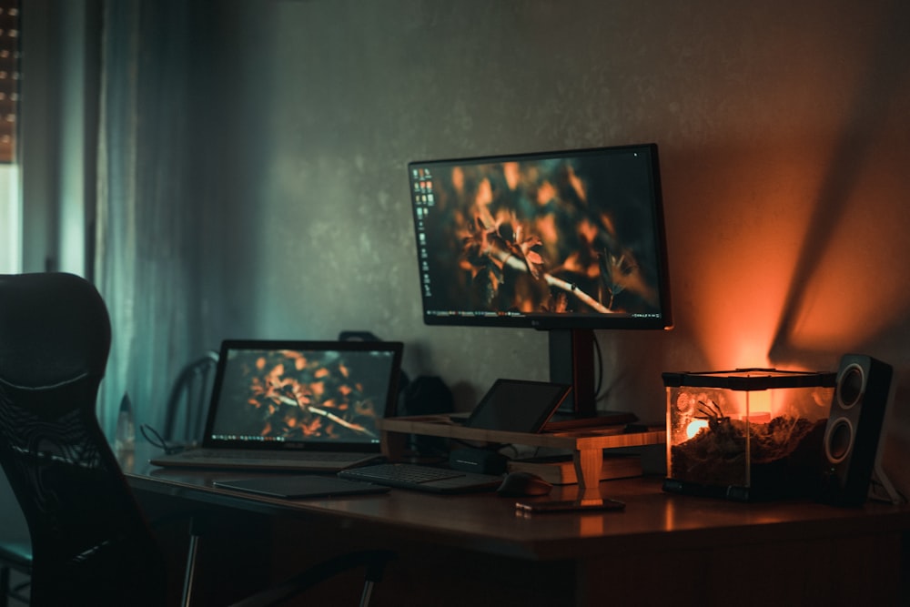 black laptop computer on brown wooden table