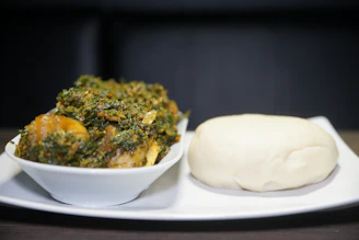 Steaming pot of amala served with smooth ewedu soup and tender meat.