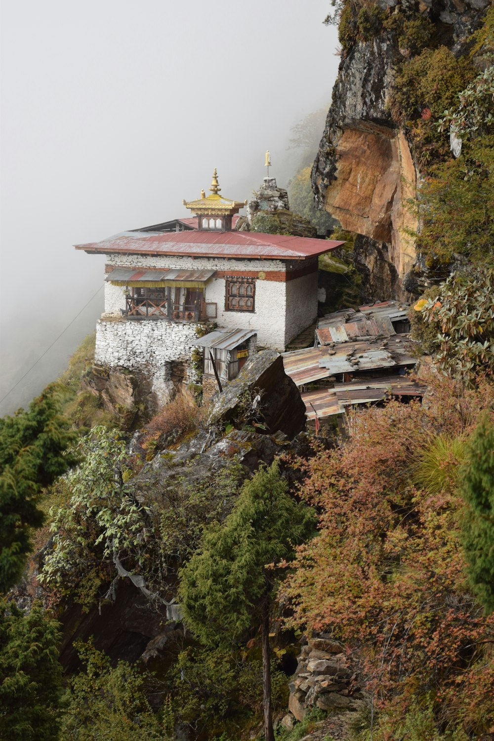 white and brown concrete house on brown rocky mountain during daytime