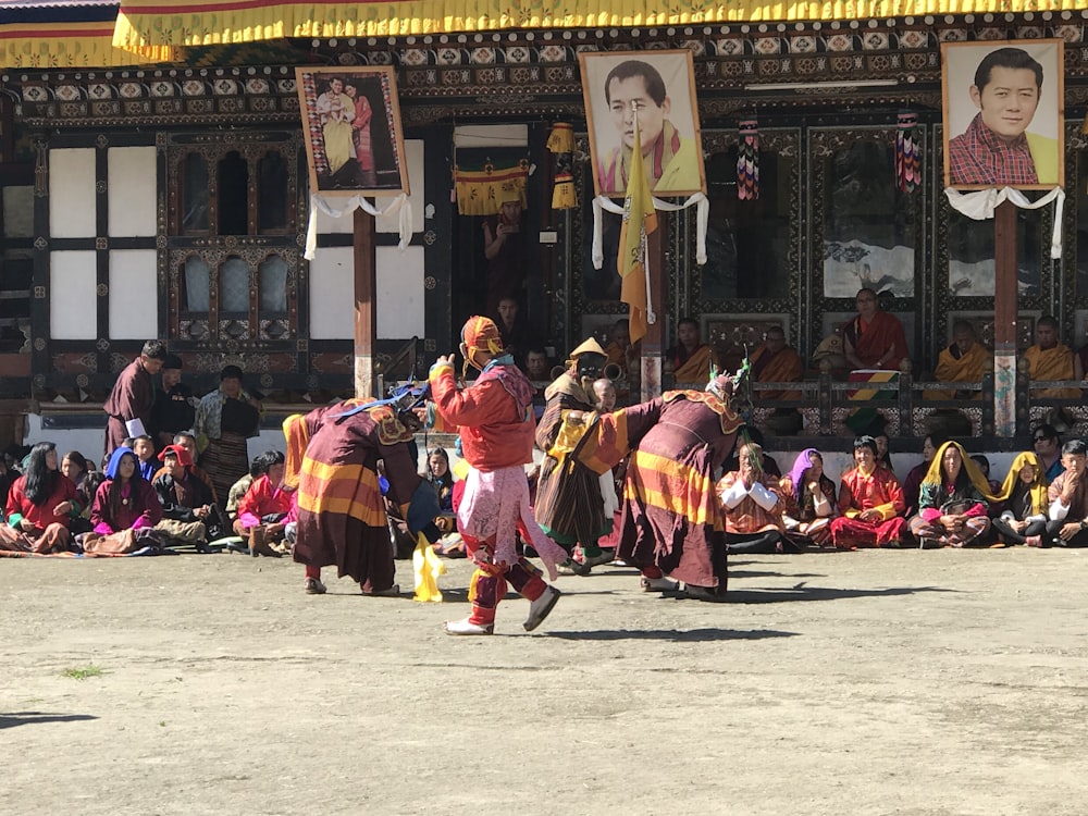 people in traditional dress dancing on street during daytime