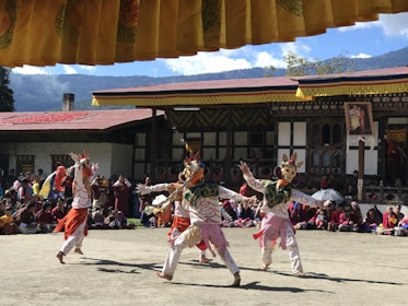Traditional Andean dancers performing in colorful costumes during a village festival.