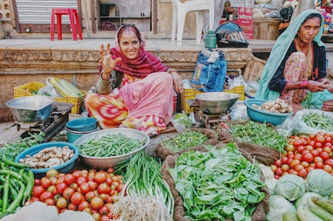 woman in pink and white stripe long sleeve shirt sitting on brown wooden chair surrounded by