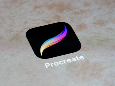 A digital icon with a black background, featuring a multicolored stylized feather. Below the icon, the text 'Procreate' is visible.