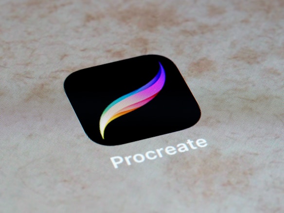 A digital icon with a black background, featuring a multicolored stylized feather. Below the icon, the text 'Procreate' is visible.
