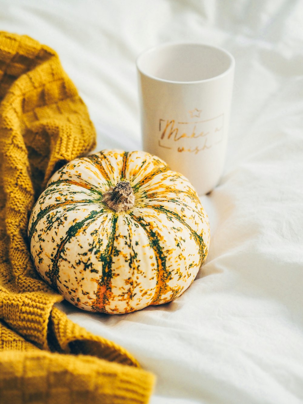 white ceramic mug beside yellow and white round fruit