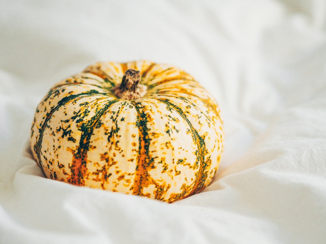yellow and green pumpkin on white textile