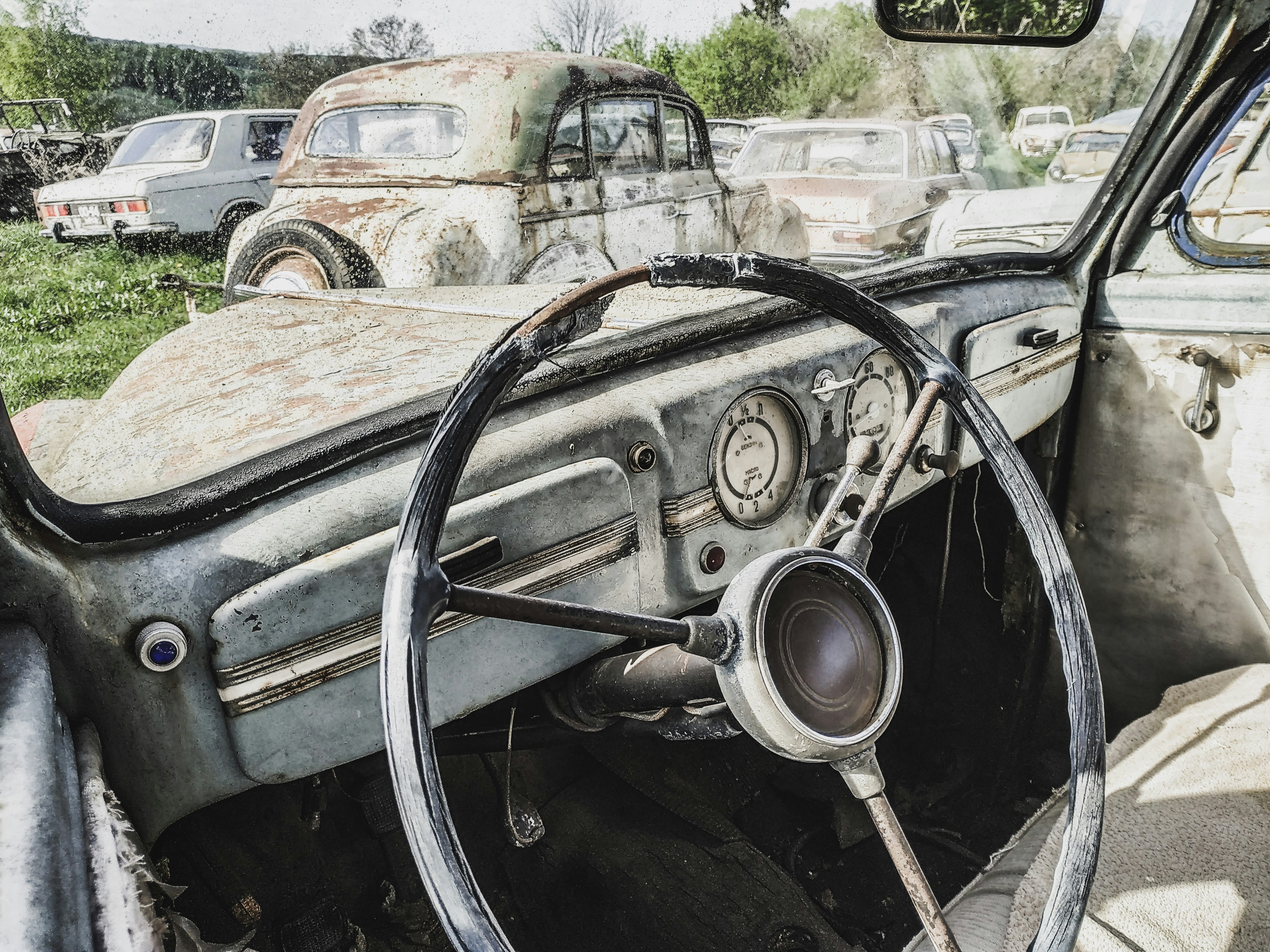 an old car with a steering wheel and dashboard